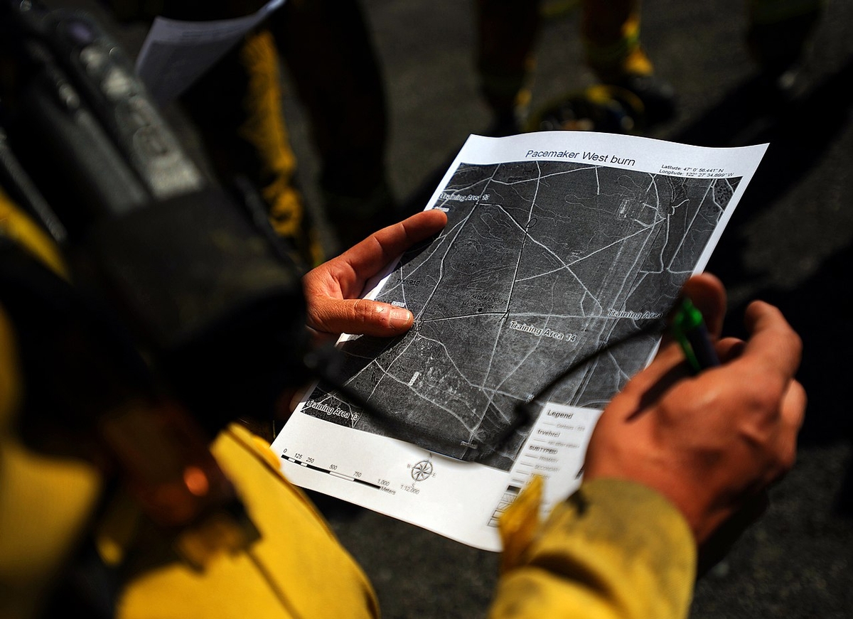 Firefighter studying a burn unit map